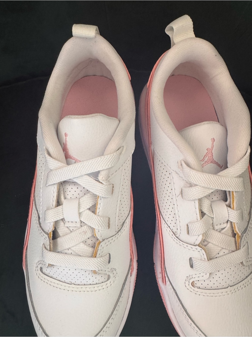 New without box.  Sold by Nike. Pink and White Low-Top Sneakers with Jordan logo